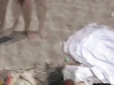 Oily teen flashing on the beach